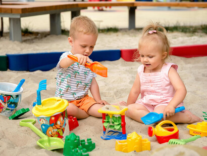 Children playing together in the sand at a playground