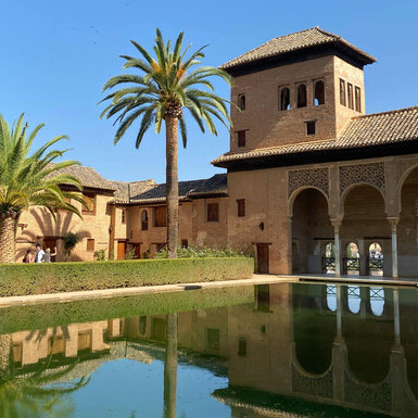Granada’s Alhambra Palace mirrored in the tranquil beauty of historic Andalusia, Spain