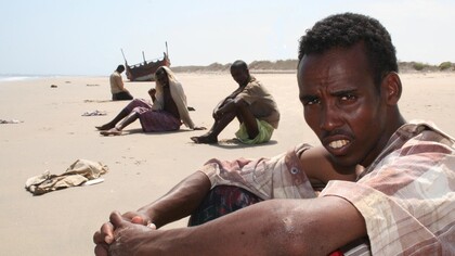 Somali migrants near a shipwreck
