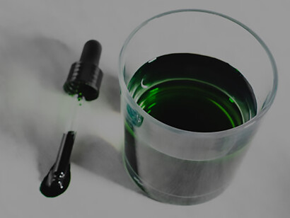 Water glass with liquid chlorophyll, representing superfood, healthy diet, and detoxification concept