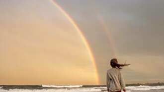 A double rainbow witnessed in solitary on the beach