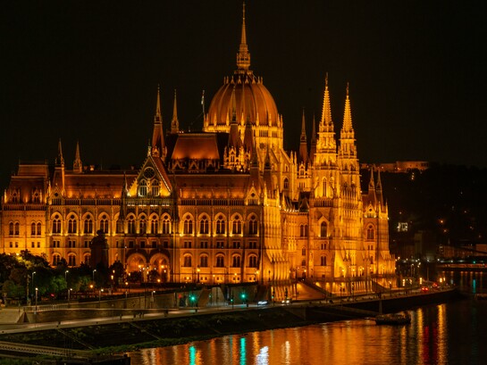 The Hungarian Parliament illuminated at night beside the Danube River, Budapest, Hungary