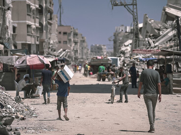 In 2024, Gaza is marked by widespread destruction, with bombed buildings reduced to rubble and people trying to survive amid the ruins