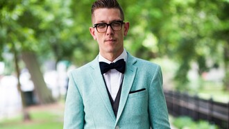 Joven vistiendo pajarita y americana celeste