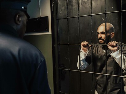 Prisoner staring at guard from his cell