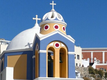 The distinctive Greek Orthodox church in Fira, Santorini, Greece, representing the ongoing relationship between language, faith, and national identity