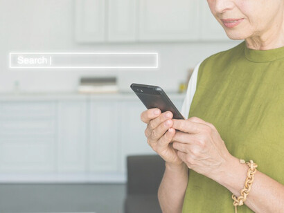 User viewing their phone with a search bar visible, illustrating AI-powered search results and the integration of Google search technology