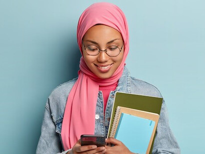 Hijabi student holding books, studying to highlight the importance of education in Islam