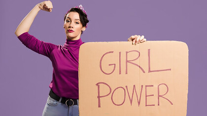 Girl power message on a cardboard sign held by a woman