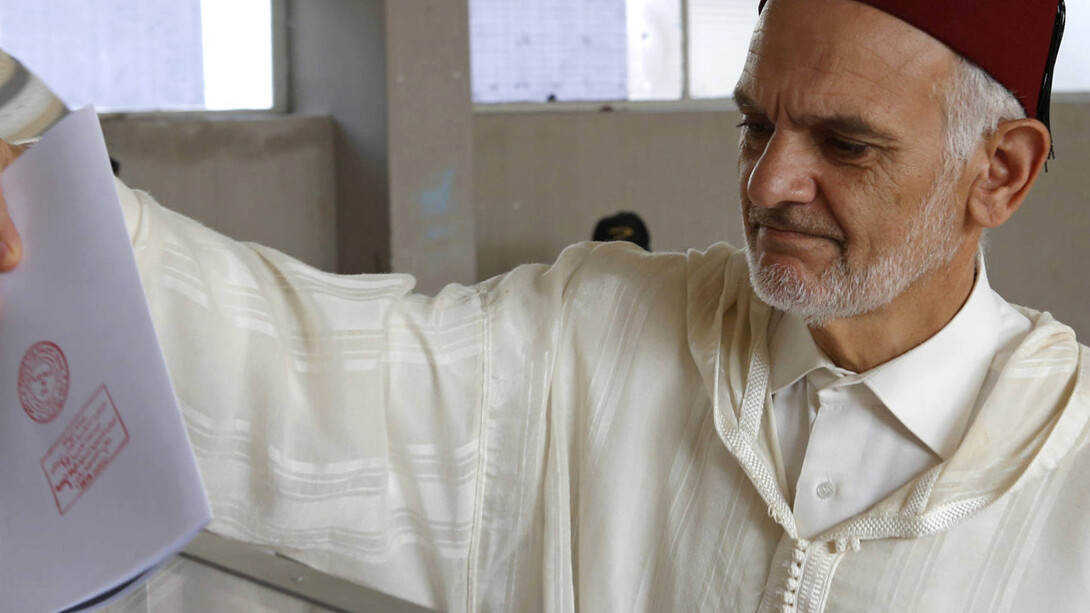 A Moroccan man casts his ballot at a polling station for the parliamentary elections in Rabat
