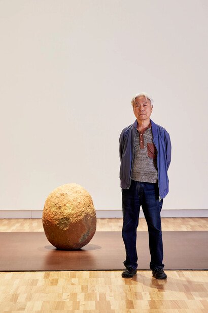 Lee Ufan with his work Relatum, position 1968/2024. Courtesy of the Art Gallery of New South Wales