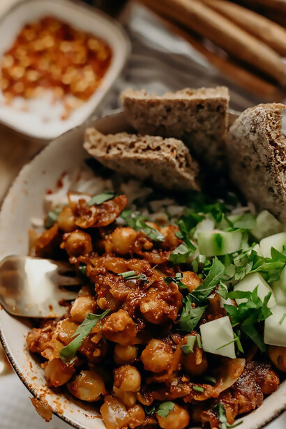 Elevate your culinary experience with a colorful and flavorful vegan stir-fry featuring the dynamic trio of rice, chickpeas, and crisp cucumber, delivering a health-conscious feast for your taste buds