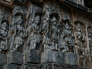 Finely chiselled stone deities and patterns in Shri Hoysaleswara Temple, Karnataka, reflecting the connection between art and worship