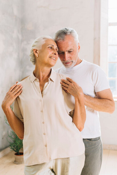 A smiling, loving senior couple embracing healthy aging through intimate connection and enduring love