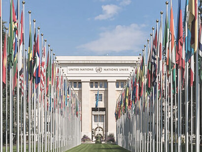 The Palace of Nations in Geneva, Switzerland, stands adorned with national flags, a testament to the United Nations' global presence