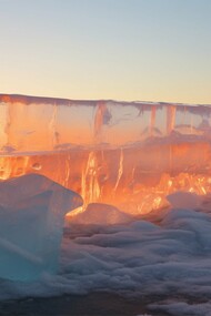 A glowing block of ice under a rising sun; a stark reminder of what’s melting away as nations falter on climate commitments