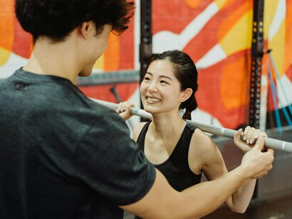 Two people in the gym lifting weights, representing how consistency turns effort into change