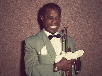Louis Armstrong, with his signature trumpet and infectious smile, embodied the vibrant energy of the 1920s jazz scene, where bold fashion choices and musical innovation went hand in hand