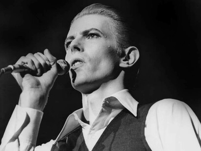 David Bowie captivating the crowd in a concert in the 1980s