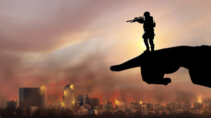 A politician's outstretched hand directs attention forward, while the metaphorical soldier of their policies aims in that chosen direction