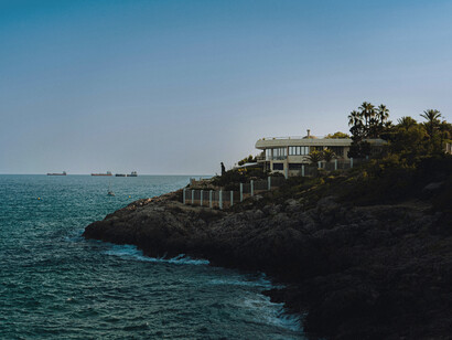 Beach house built on top of the rocky cliffs. Tarragona, Spain