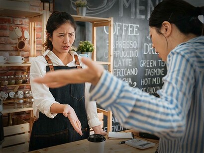 A customer at a coffee house complaining to the barista 