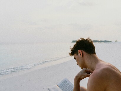 Person reading on the beach. The right book can steer an eager learner in the right direction
