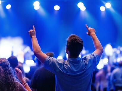Theatre audience reacting emotionally while standing