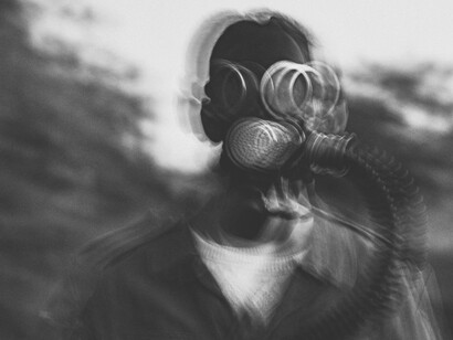 An unsettling, jittery picture of a man in a gas mask