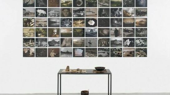 Michelle Stuart (American, born 1931), Ring of Fire, 2008-09/2010, Wall piece: inkjet-printed analog photographs, archival paper, 58 x 119 inches, Metal table: stones, wood container, seeds, Tonga tapa cloth, cotton cloth, basket, 28 ½ x 40 x 18 inches, 2013 © Michelle Stuart, Courtesy Leslie Tonkonow Artworks + Projects, New York