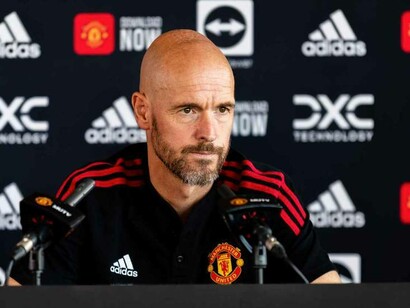 Erik ten Hag listening to a question posed by a reporter at the Manchester United press conference