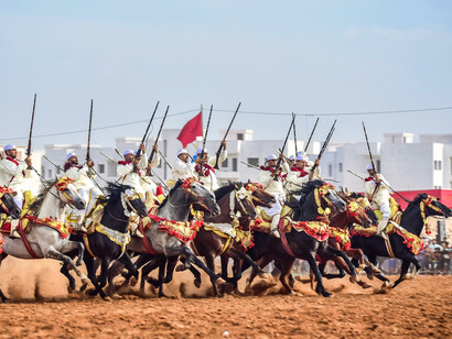 Traditional Moroccan Fantasia horsemen performing a time-honoured ritual, reflecting the role of heritage in sustaining strategic consistency