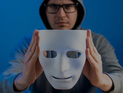 Someone concealing their identity online with a mask, highlighting the anonymity often seen in internet interactions