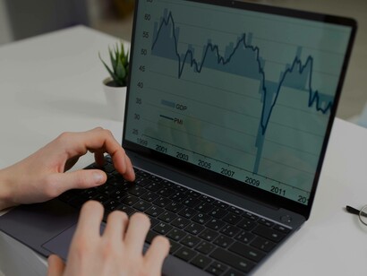 An employee inputting the market research on their laptop