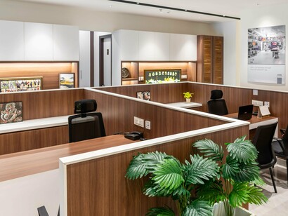 Rows of empty desks in a modern office, symbolising a workforce being reshaped by AI-driven efficiencies