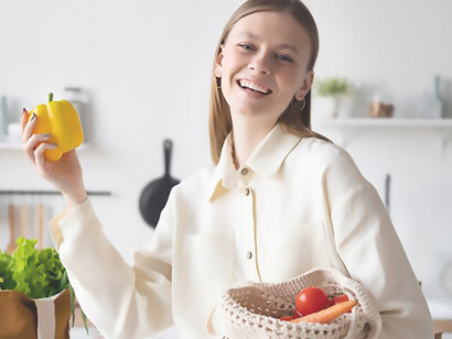 A woman embraces the use of sustainable fabric bags over conventional shopping bags