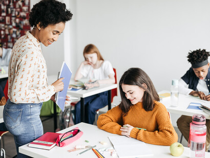Teacher and her students during a lesson. Visualize how you are thought of and seen as a teacher. Try to see your facial expressions during the session and your posture, and take note of it