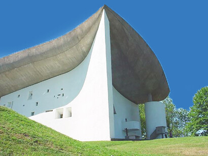 Le Corbusier's revolutionary design for Notre Dame du Haut redefines sacred space with organic forms and minimalist beauty, Ronchamp, France