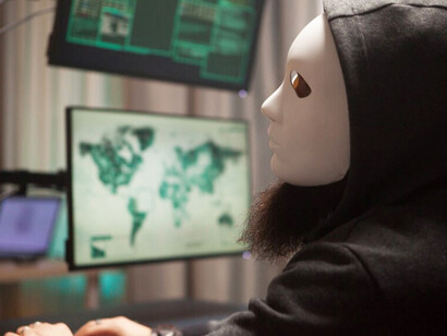 A masked cybercriminal in profile, representing the rise of hybrid threats, terrorism, and the influence of artificial intelligence in modern conflicts