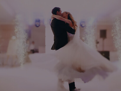 Capture the joy of newly married bliss with a groom lifting the bride during their wedding dance, a heartwarming moment to cherish forever