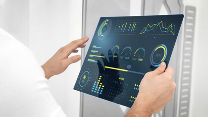 Close-up of a hand holding a futuristic digital screen