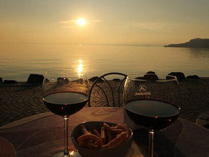 A glass of red wine at sunset