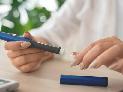 A woman with diabetes diligently monitors her glucose levels