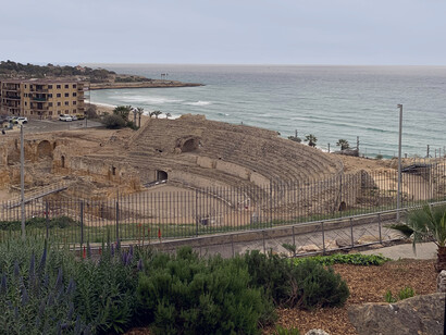 A statue of a priest overlooks the Mediterranean Sea