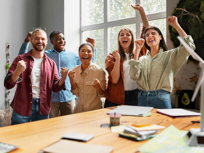 A cross-functional team celebrates a milestone in their eco-initiative, proving that purpose-driven collaboration can lead to real business growth and positive environmental impact