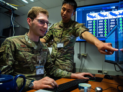 U.S. Air Force 1st. Lt. Chris Tran, left, 51st Network Operations Squadron deputy flight commander assigned to Langley Air Force Base, Virginia, and Senior Airman Frederic Borries, right, 52nd Communications Squadron chief of training assigned to Spangdahlem Air Base, Germany, simulate a high fidelity traffic environment for a cyber range during exercise Tacet Venari at Ramstein Air Base, Germany, May 12, 2022