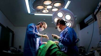Doctors performing surgery in an operating room