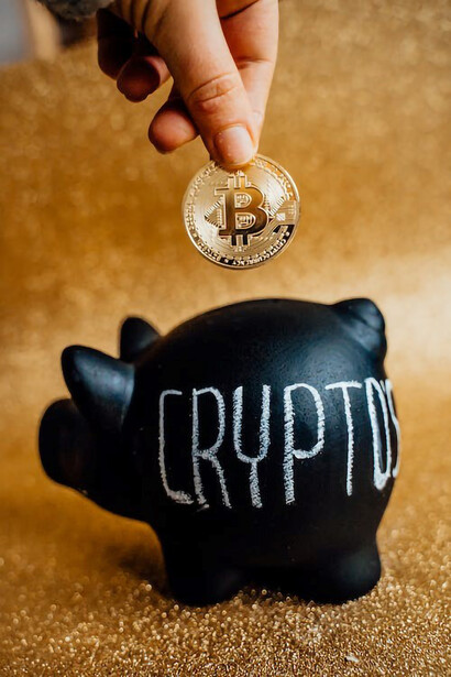 A person carefully places bitcoins into a digital piggy bank, symbolizing their commitment to saving and investing in the world of cryptocurrency