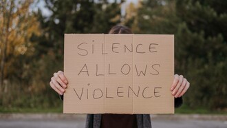 A sign pleading to speak up against injustice