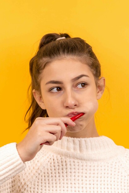 Teenage girl using a tooth brush